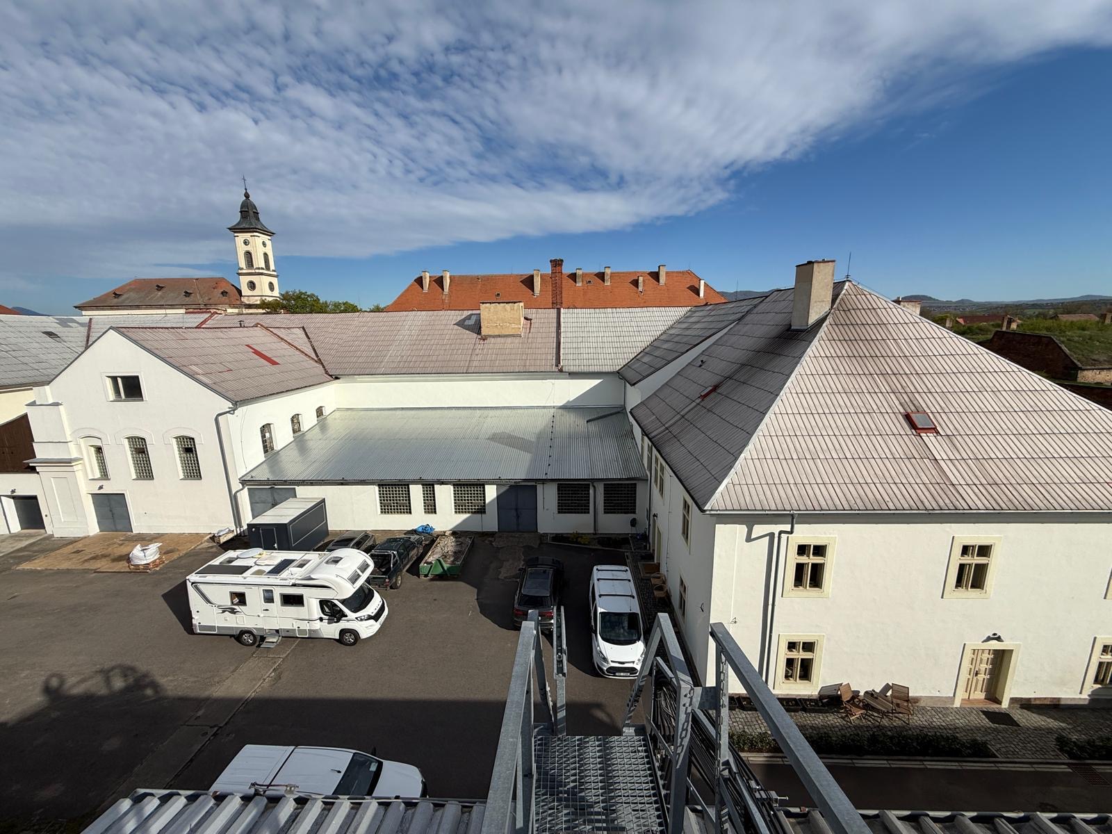 Reálný pohled na současný areál bývalého pivovaru v Terezíně s kostelní věží v pozadí